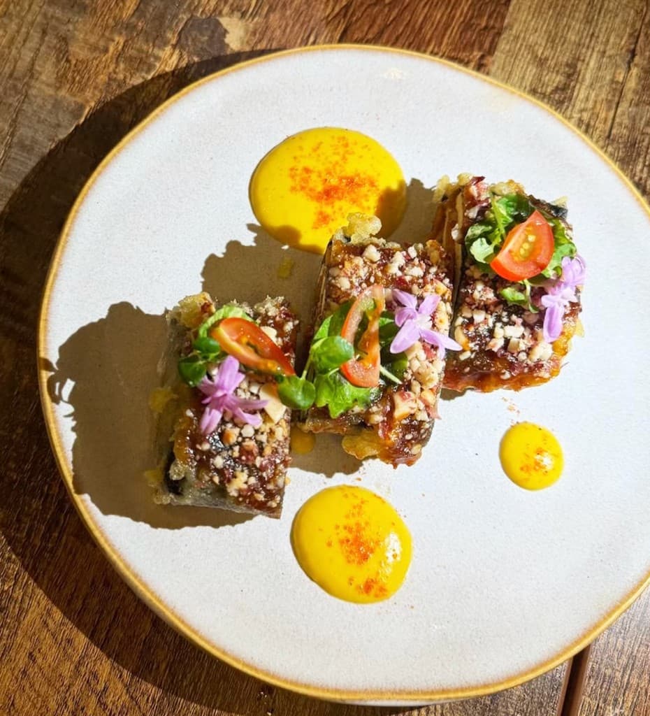 Dessert with nut glaze and edible flowers