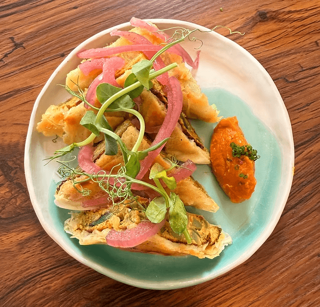 Roti jala with dhal and pickled onion