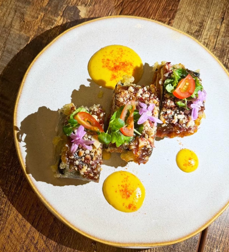 Dessert with nut glaze and edible flowers